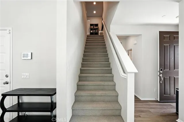 a view of entryway and hall with wooden floor