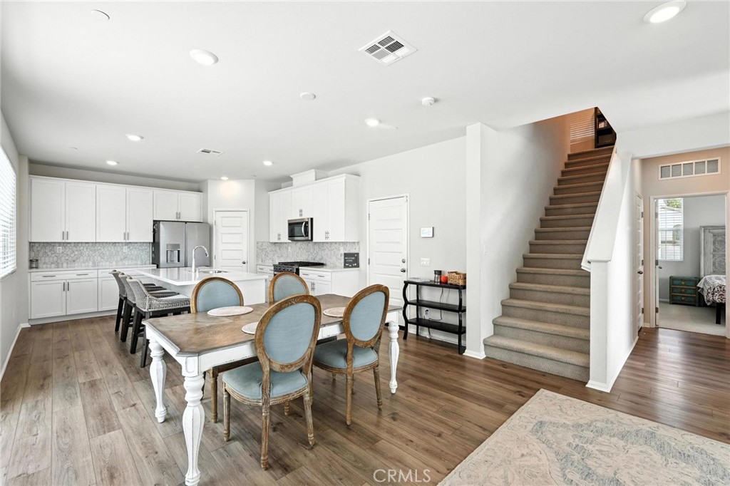 28267 Ashtree Street Temecula, CA 92591 - Photo 15 of 41 a view of a dining room with furniture and wooden floor