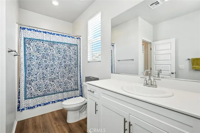 a bathroom with a sink toilet a mirror and shower