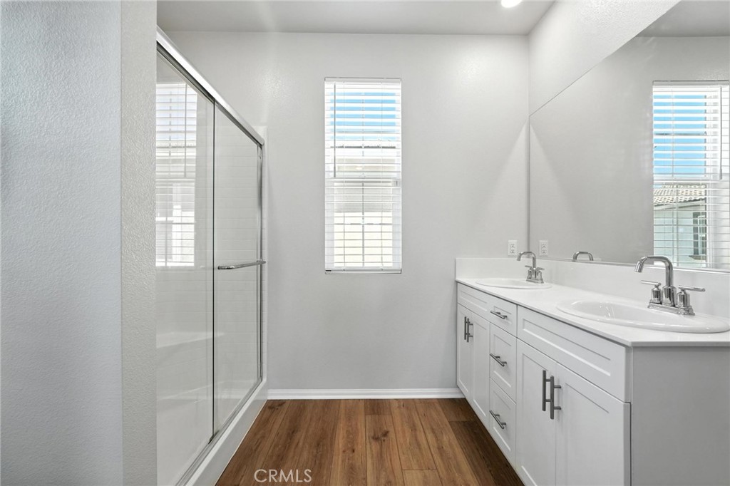 28267 Ashtree Street Temecula, CA 92591 - Photo 27 of 41 a bathroom with a sink a mirror and a shower