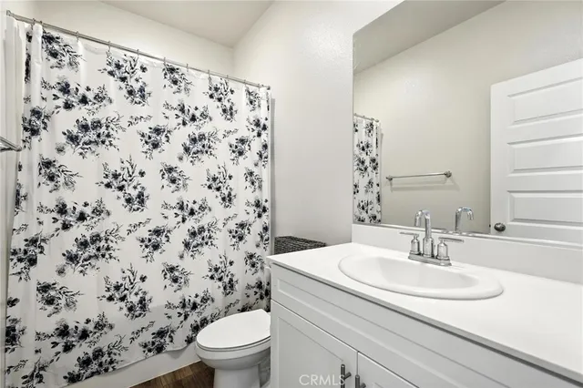 a bathroom with a sink toilet and a mirror