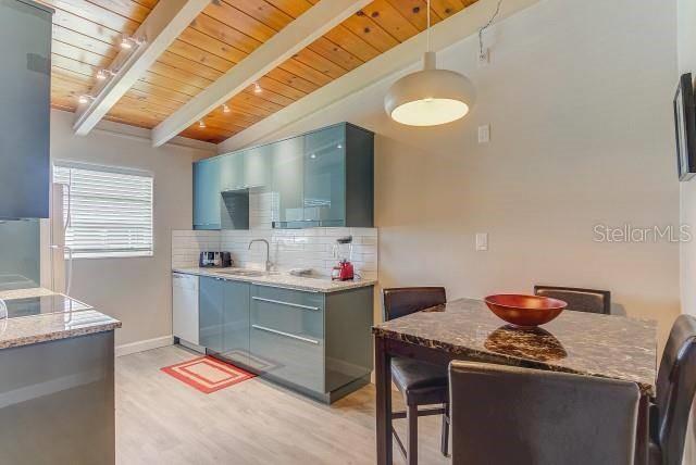 6006 Midnight Pass Road, Unit 24 Sarasota, FL 34242 - Photo 4 of 16 a room that has a sink and a stove in it