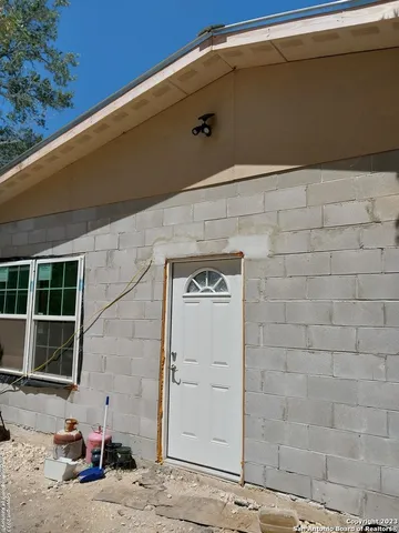 a backyard of a house with table and chairs