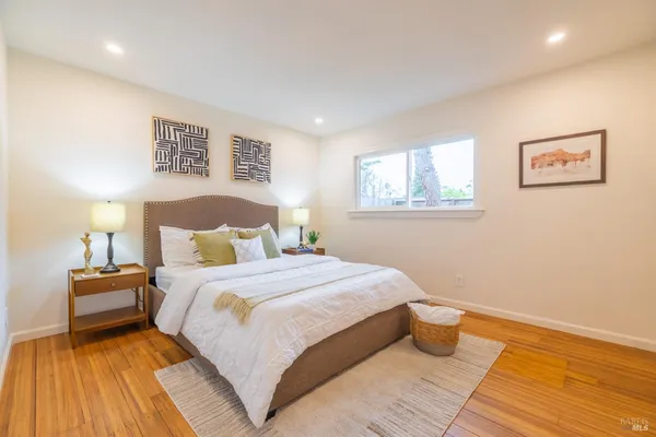 a bedroom with a bed and a night stand