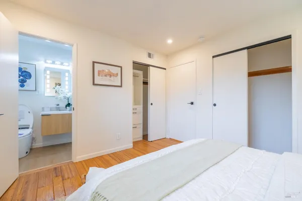 a bedroom with a bed and a view of bathroom