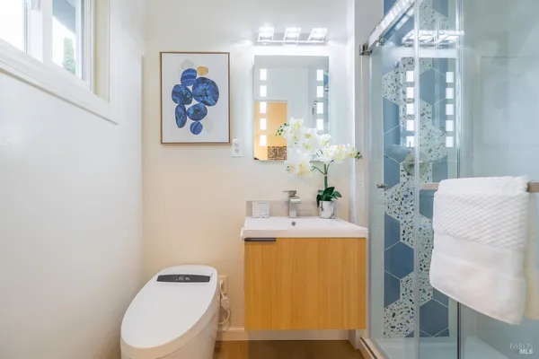 a bathroom with a toilet sink and mirror