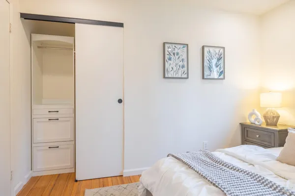 a bedroom with a bed and the view of a bathroom