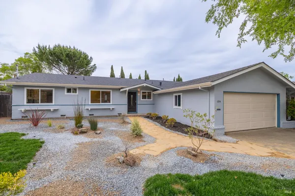a house view with a sitting space and wooden fence