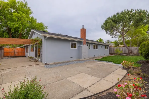 a front view of house with a garden