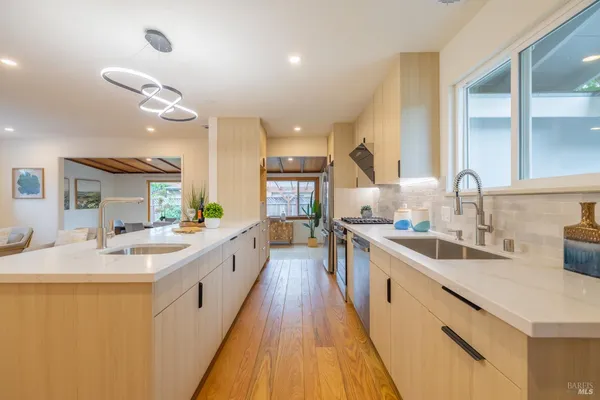 a large kitchen with kitchen island a large counter space a sink and appliances