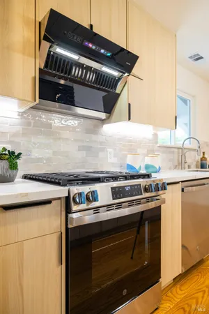 a kitchen with granite countertop a stove and a sink