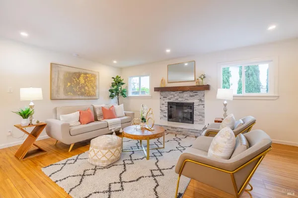 a living room with furniture and a fireplace