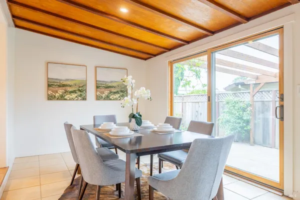 a view of a dining room with furniture large windows and wooden floor