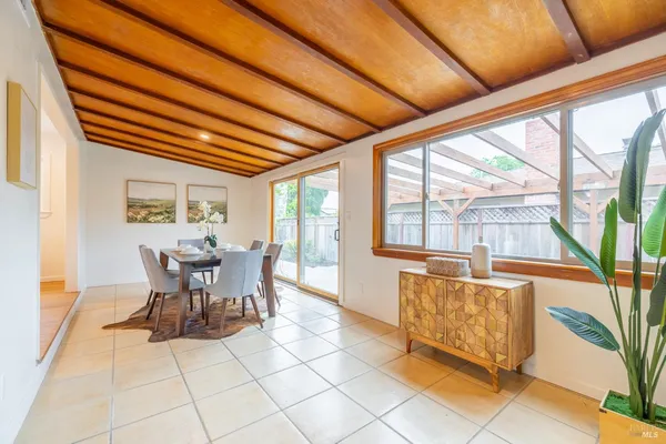 a view of a dining room with furniture window and outside view