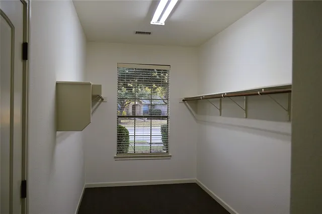 a view of walk in closet with window