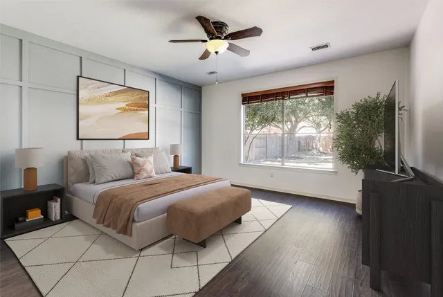 a bedroom with bed and large windows