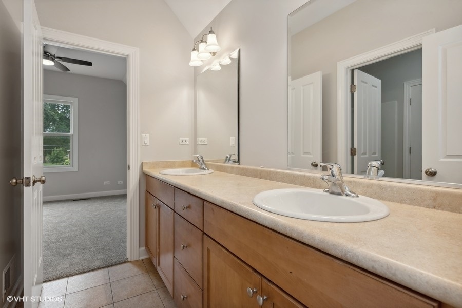 452 Mildred Avenue Cary, IL 60013 - Photo 14 of 20 a bathroom with a sink and a mirror