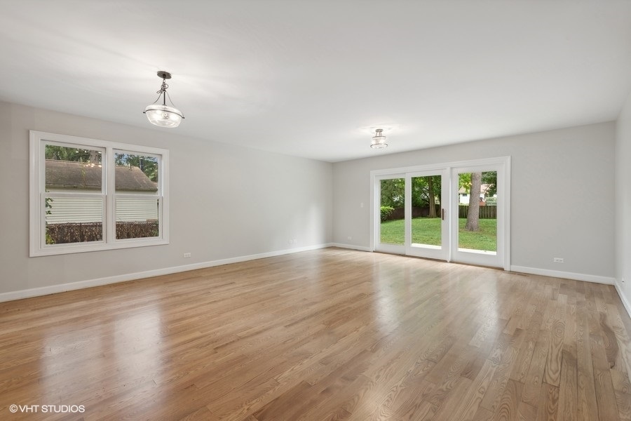 452 Mildred Avenue Cary, IL 60013 - Photo 3 of 20 a view of an empty room with wooden floor and a window