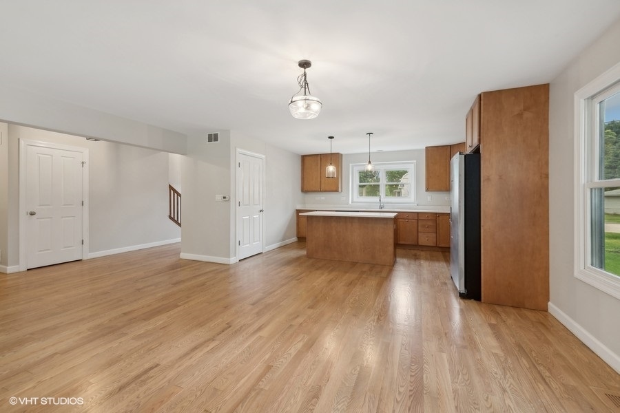 452 Mildred Avenue Cary, IL 60013 - Photo 5 of 20 a view of a kitchen with wooden floor and a refrigerator