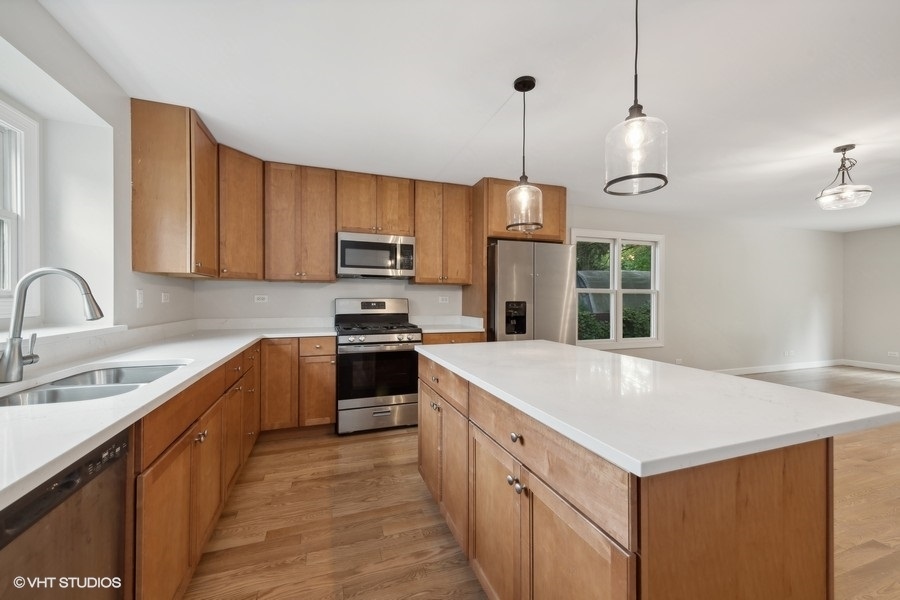 452 Mildred Avenue Cary, IL 60013 - Photo 7 of 20 a kitchen with a sink stove and refrigerator