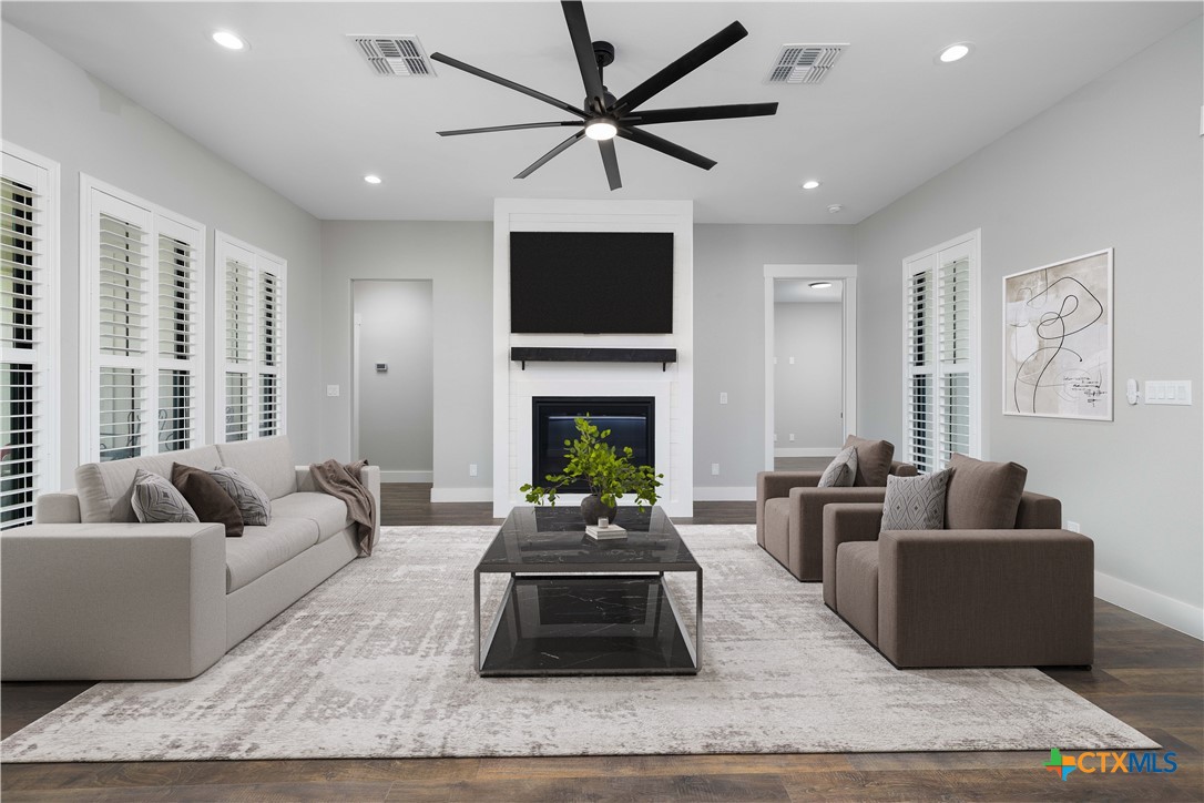 537 Compass Rose Spring Branch, TX 78070 - Photo 4 of 29 a living room with furniture a flat screen tv and a fireplace