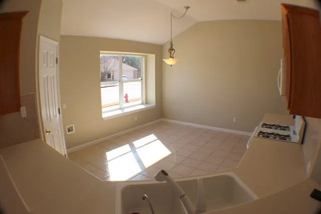 a bathroom with a window and a shower