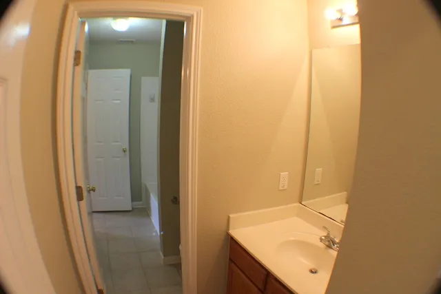 a bathroom with a sink and mirror