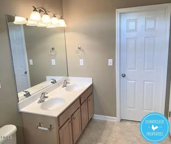 a bathroom with a double vanity sink and a mirror