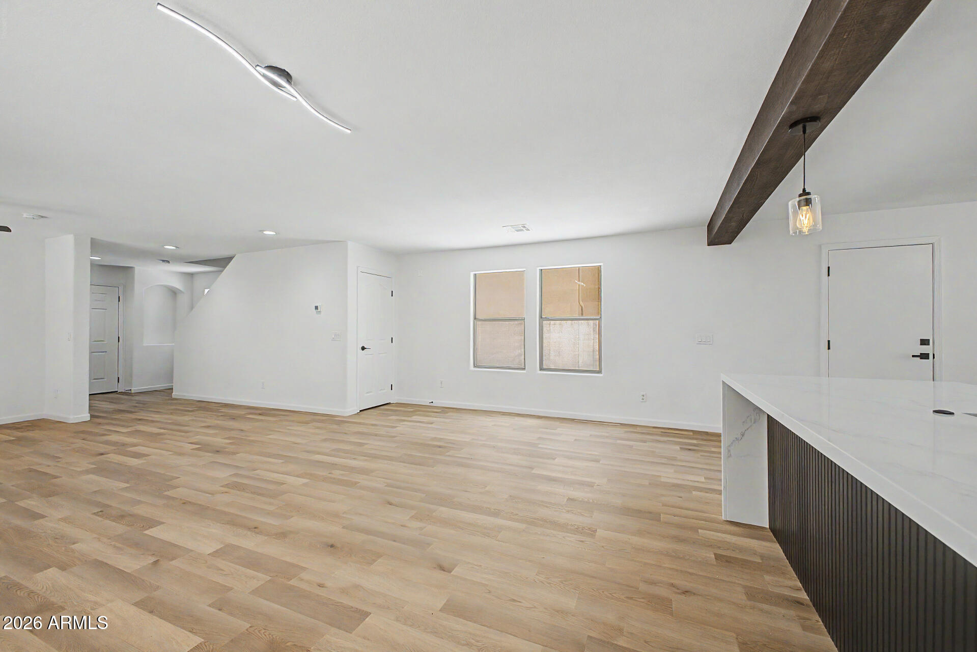 6452 West Ruth Avenue Glendale, AZ 85302 - Photo 10 of 35 a view of an empty room with wooden floor and a window
