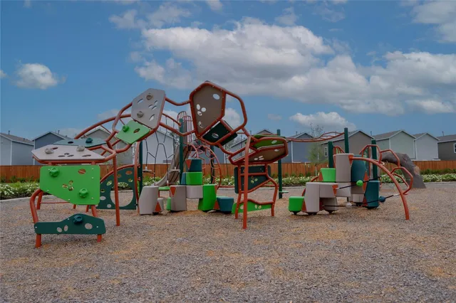 a view of outdoor space with playground and green space
