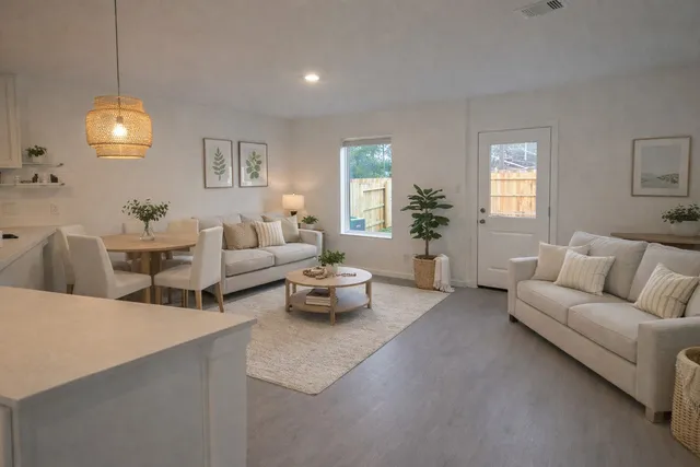 a living room with furniture kitchen and a chandelier