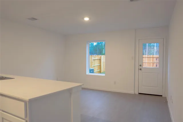 an empty room with windows and closet