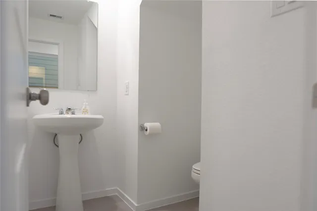 a bathroom with a sink toilet
