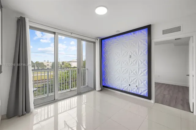 a view of empty room with large windows