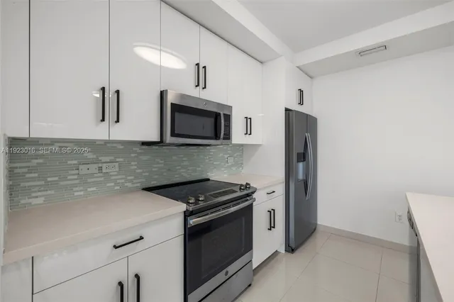 a kitchen with stainless steel appliances a refrigerator stove and microwave
