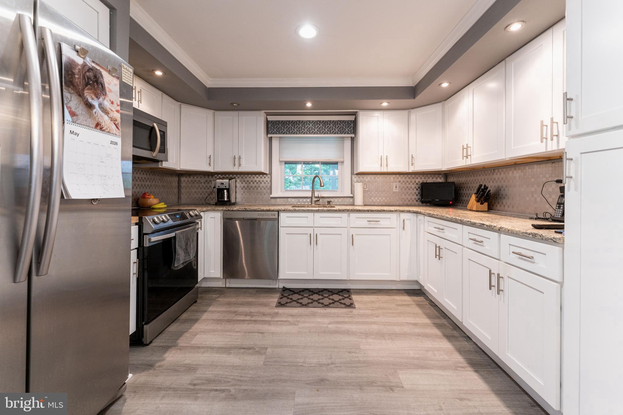 2941 Pheasant Run Road Norristown, PA 19403 - Photo 11 of 23 a kitchen with white cabinets stainless steel appliances and sink