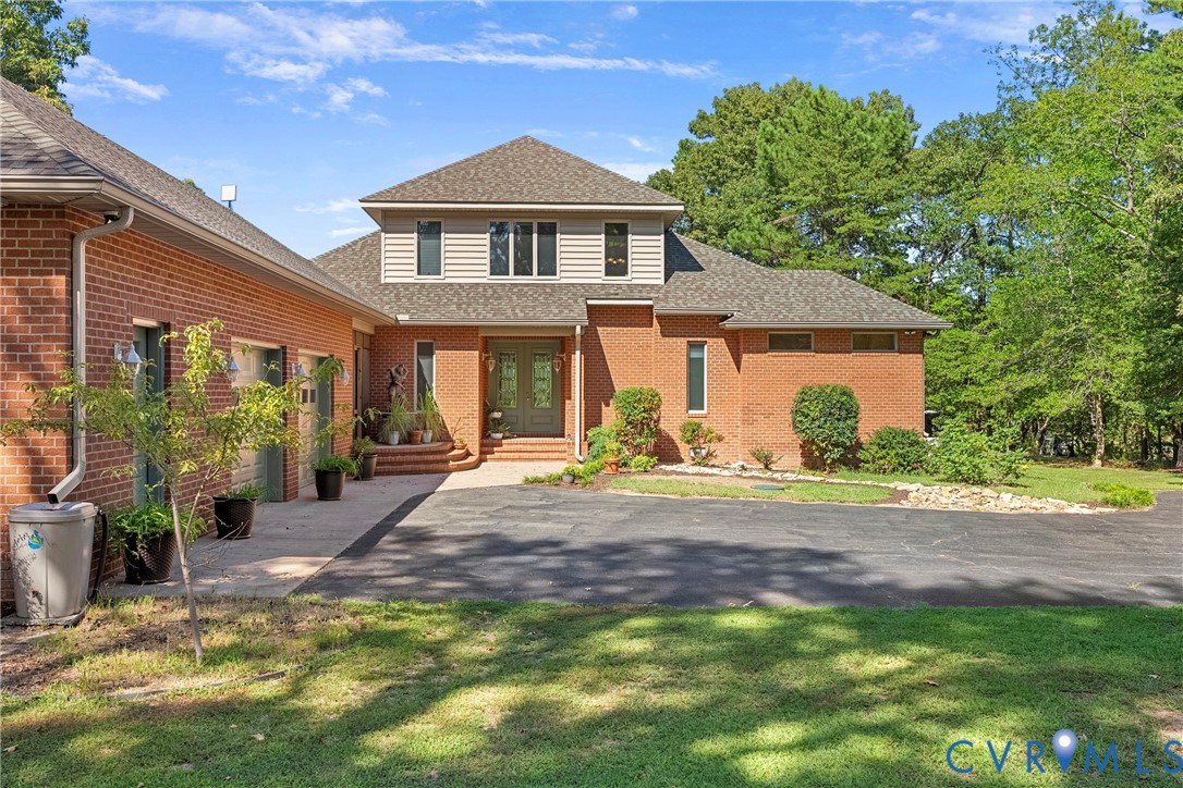447 Tranquility Road Reedville, VA 22539 - Photo 7 of 82 Brick exterior with an asphalt driveway, concrete