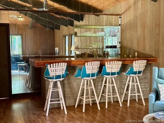 a dining area with chairs and wooden floor