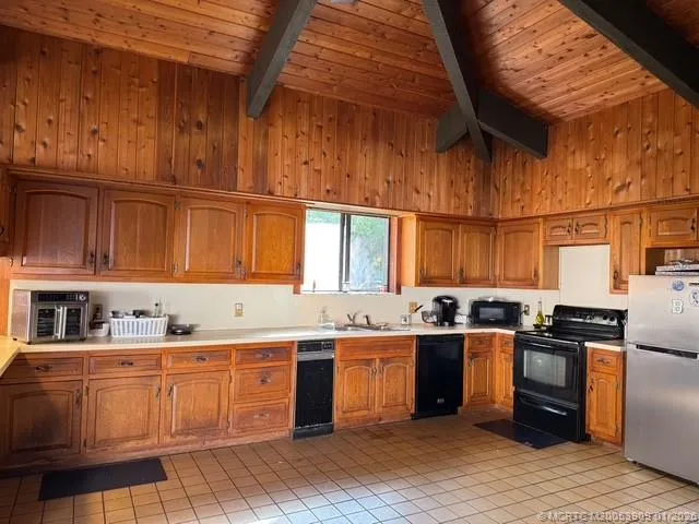 a kitchen with stainless steel appliances granite countertop a sink and cabinets