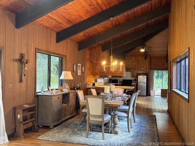 a dining room with furniture window and wooden floor
