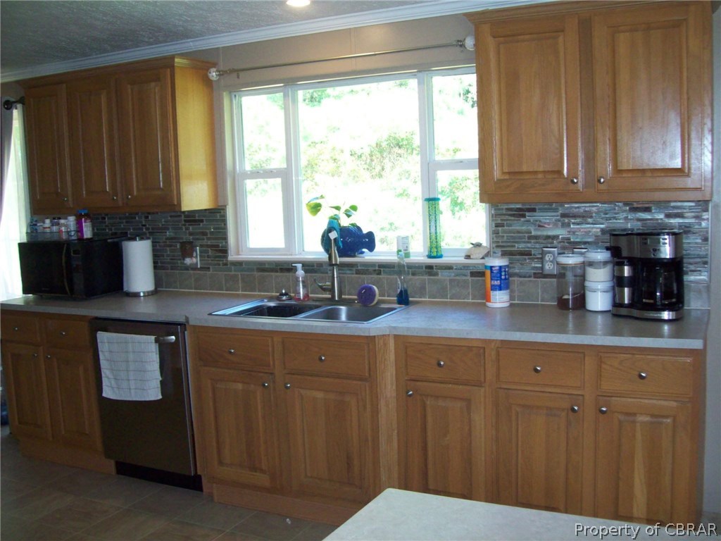 133 Dixon Road Hudgins, VA 23076 - Photo 10 of 25 a kitchen with stainless steel appliances granite countertop white cabinets a sink and dishwasher