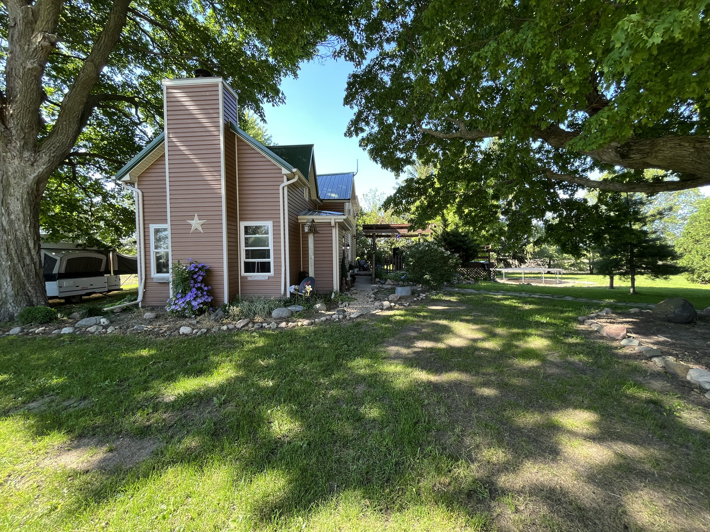 22670 Larson Road Sycamore, IL 60178 - Photo 1 of 41 a backyard of a house with plants and large trees