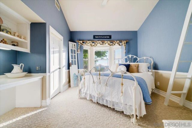 a spacious bedroom with a bed and a chandelier