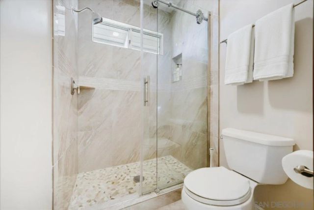 a view of a roof deck with couches and sky view