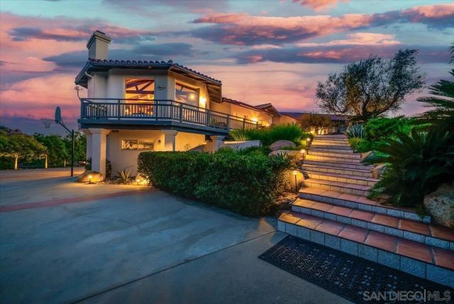 a view of a backyard with plants and a patio