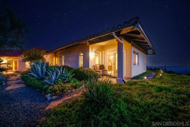 a view of a livingroom with wooden floor and a porch