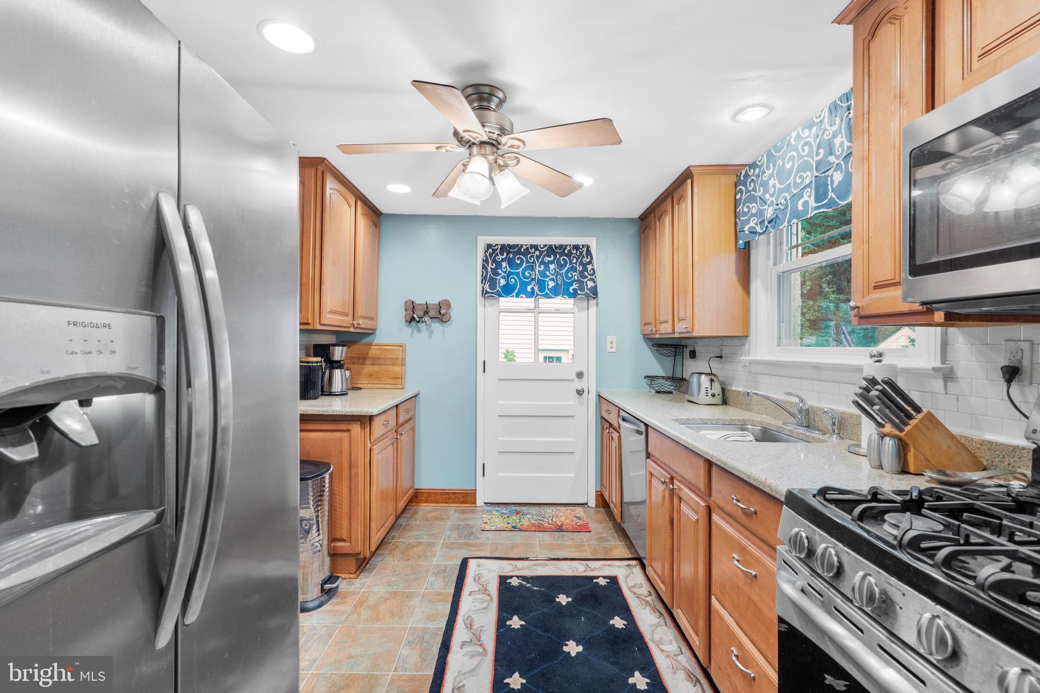 2589 Radcliffe Road Broomall, PA 19008 - Photo 12 of 34 a kitchen with stainless steel appliances granite countertop a sink stove and refrigerator