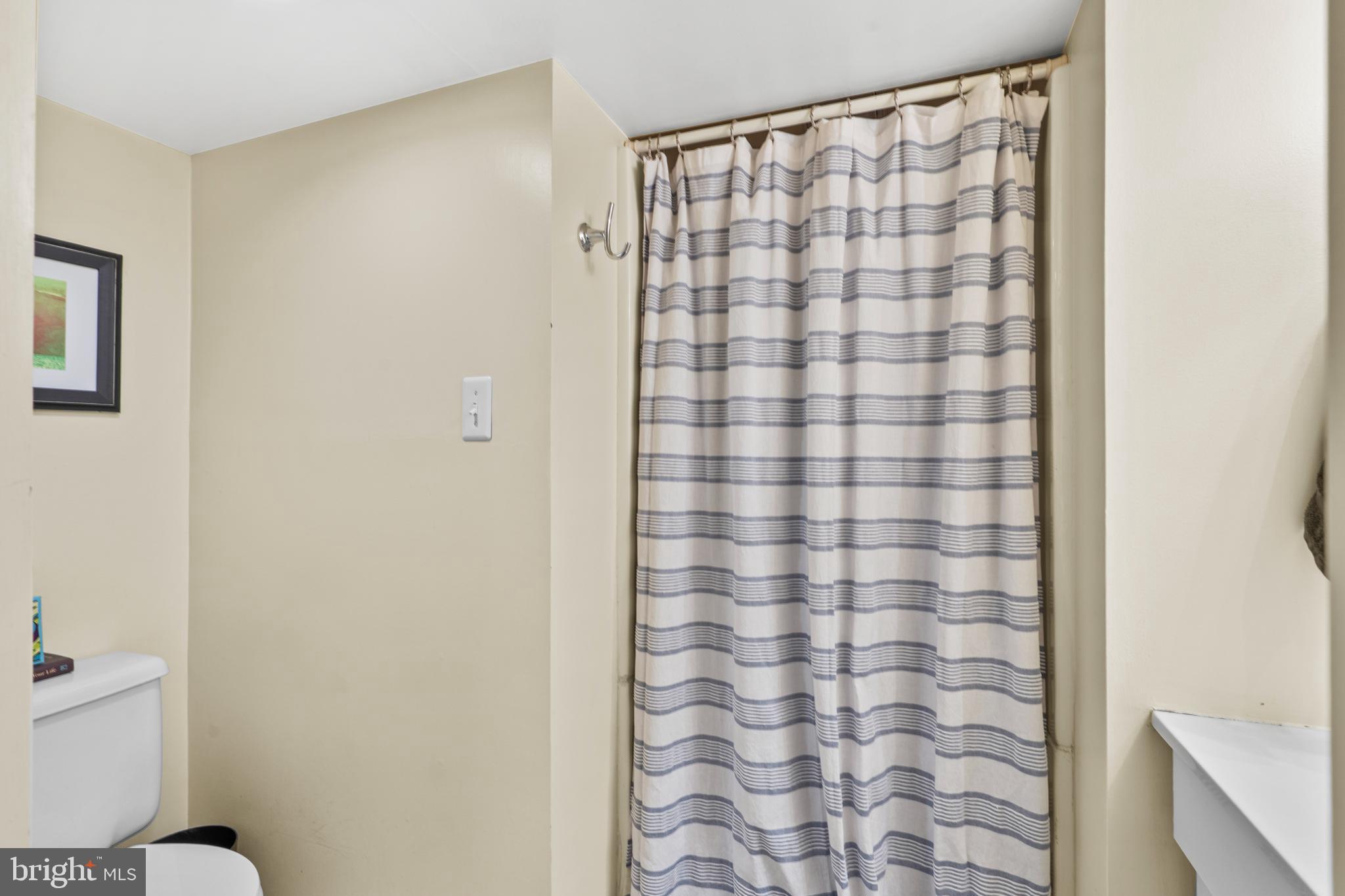 2589 Radcliffe Road Broomall, PA 19008 - Photo 25 of 34 a bathroom with a shower curtain