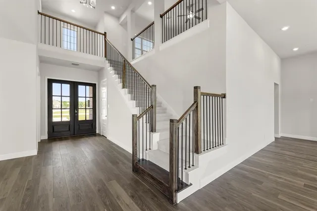 a view of staircase with white walls and a window