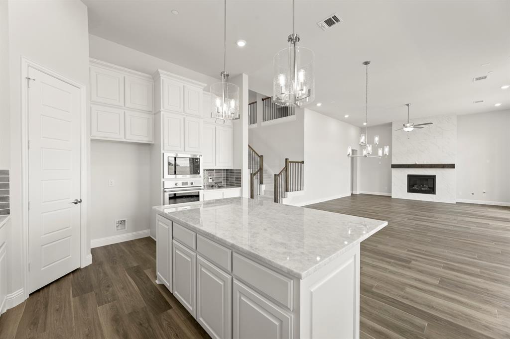 403 Spoonbill Road Sunnyvale, TX 75182 - Photo 15 of 34 a kitchen with kitchen island a sink stainless steel appliances and cabinets